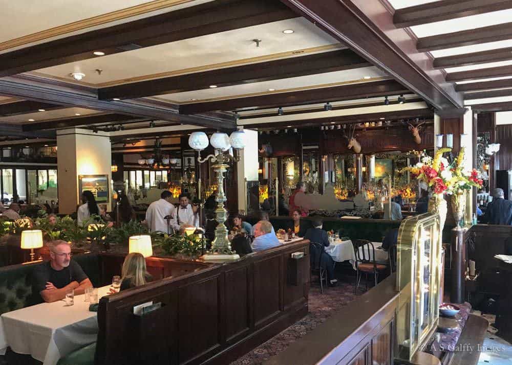 People eating in the Old Ebbit Grill dining room People eating in the Old Ebbitt Grill dining room
